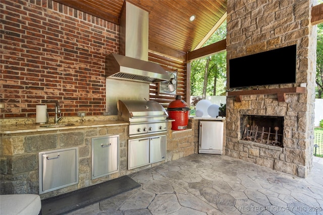 11406 69th E Pl, Bixby, OK 74008 - view of patio / terrace featuring an outdoor stone fireplace and an outdoor kitchen