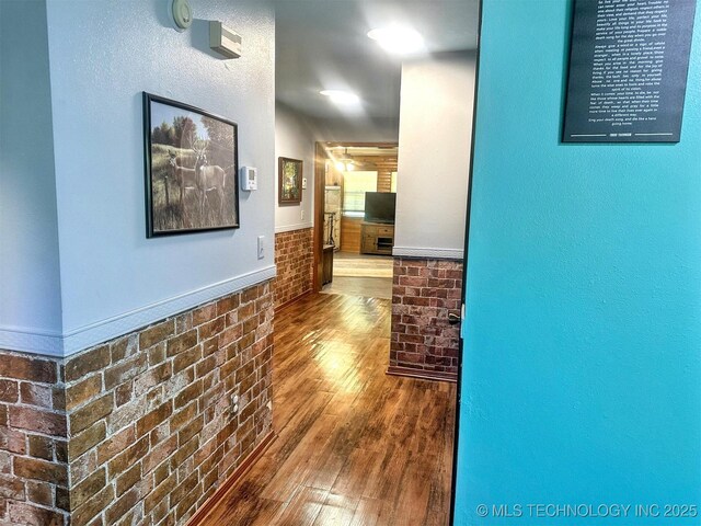 3293 W Southern Ave, Hulbert, OK 74441 - corridor featuring wood finished floors, wainscoting, and brick wall