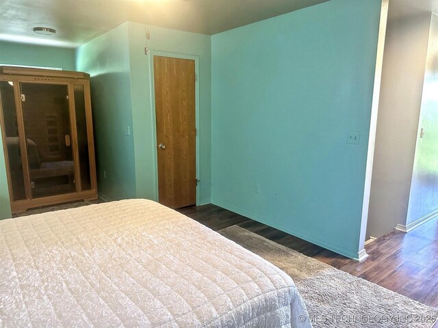 3293 W Southern Ave, Hulbert, OK 74441 - bedroom featuring dark wood-style flooring and baseboards