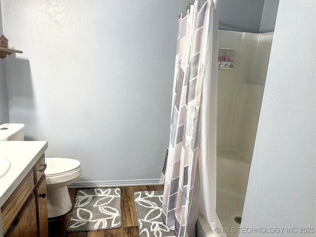 3293 W Southern Ave, Hulbert, OK 74441 - bathroom with vanity, toilet, wood finished floors, a stall shower, and baseboards