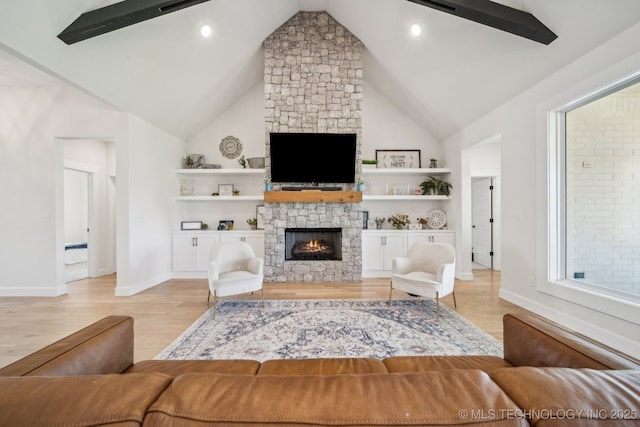 123 S 168th St, Glenpool, OK 74033 - living area with light wood-type flooring, a stone fireplace, high vaulted ceiling, and recessed lighting