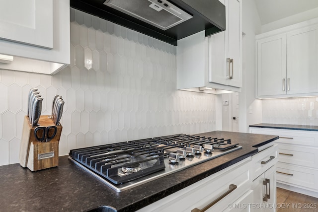 123 S 168th St, Glenpool, OK 74033 - kitchen featuring range hood, stainless steel gas stovetop, decorative backsplash, white cabinets, and dark stone countertops