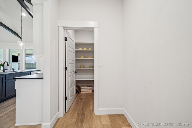 123 E 168th St, Glenpool, OK 74033 - corridor featuring light wood-style floors, baseboards, and a sink