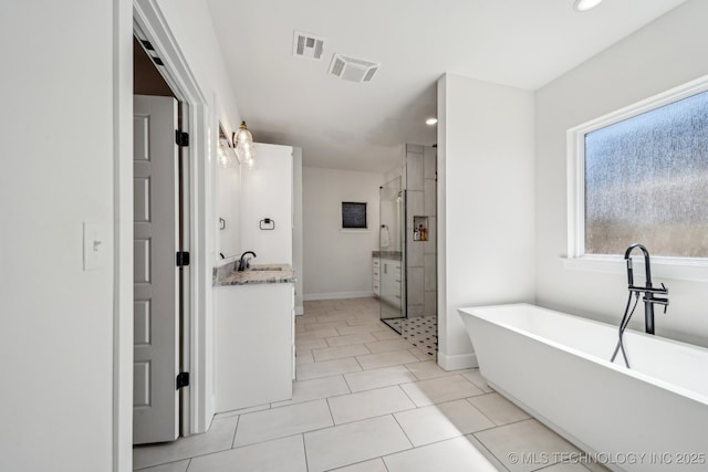 123 E 168th St, Glenpool, OK 74033 - bathroom featuring a stall shower, vanity, a soaking tub, recessed lighting, and baseboards