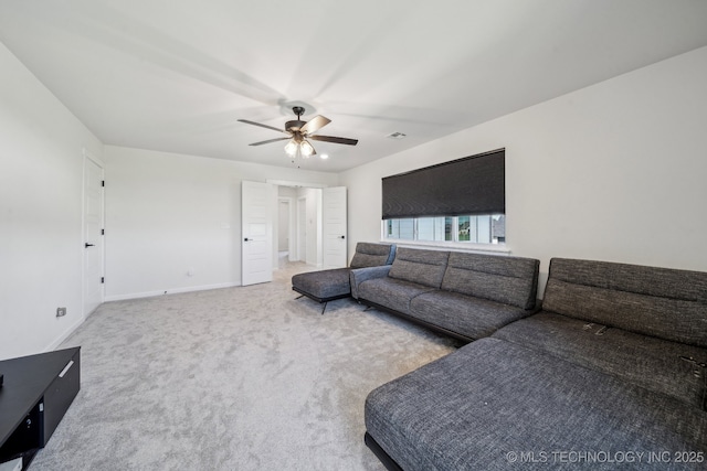 123 E 168th St, Glenpool, OK 74033 - carpeted living room with a ceiling fan and baseboards