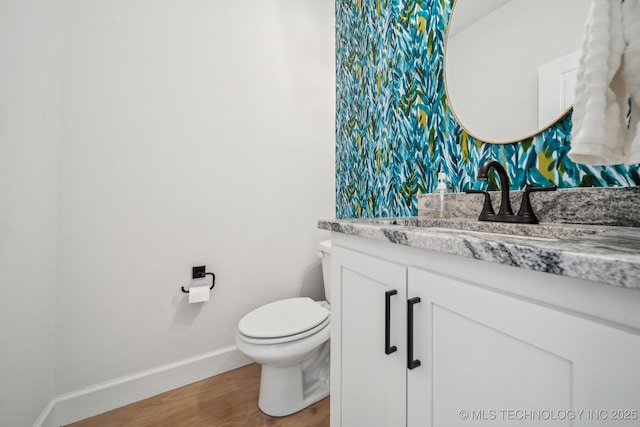 123 S 168th St, Glenpool, OK 74033 - bathroom featuring vanity, wood finished floors, and wallpapered walls