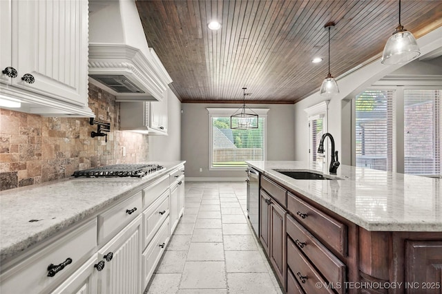 2236 W Charlotte St, Broken Arrow, OK 74011 - kitchen with a sink, premium range hood, stainless steel appliances, white cabinetry, and ornamental molding