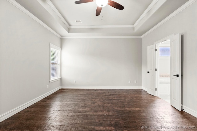 2236 W Charlotte St, Broken Arrow, OK 74011 - empty room with a tray ceiling, healthy amount of natural light, a ceiling fan, dark wood-type flooring, and crown molding