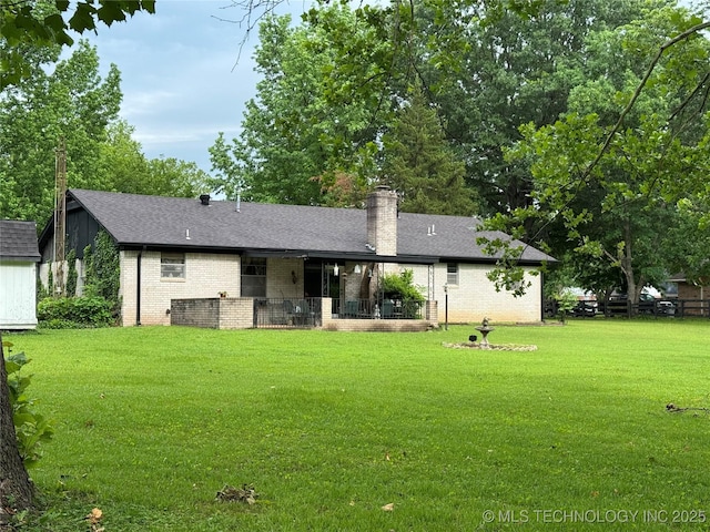 7122 S Shelby Ln, Broken Arrow, OK 74014 - rear view of property featuring brick siding, a yard, a chimney, a shingled roof, and a patio