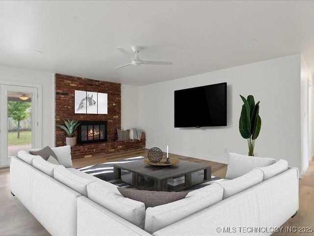 817 N Ivy St, Jenks, OK 74037 - living area featuring a brick fireplace, a ceiling fan, and wood finished floors