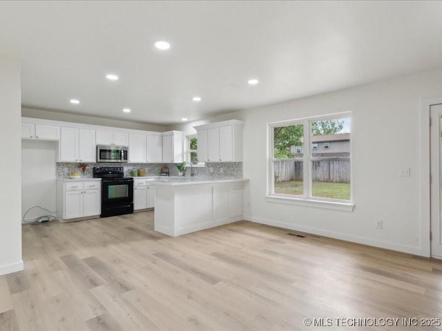 817 N Ivy St, Jenks, OK 74037 - kitchen with stainless steel microwave, black range with electric cooktop, light countertops, tasteful backsplash, and recessed lighting