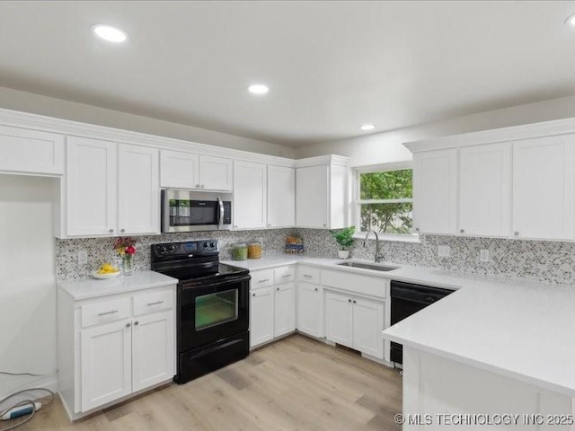 817 N Ivy St, Jenks, OK 74037 - kitchen with black appliances, a sink, white cabinets, and recessed lighting