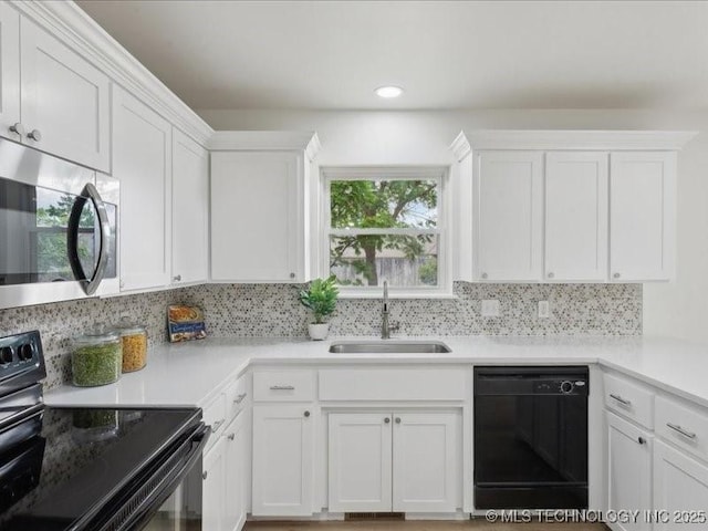 817 N Ivy St, Jenks, OK 74037 - kitchen featuring black appliances, a sink, white cabinets, tasteful backsplash, and light countertops