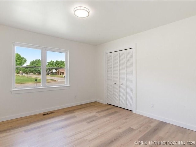 817 N Ivy St, Jenks, OK 74037 - unfurnished bedroom featuring light wood-type flooring, baseboards, and a closet
