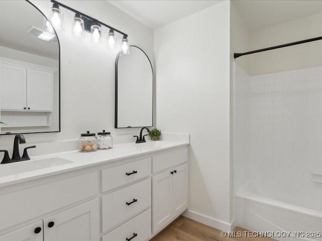 817 N Ivy St, Jenks, OK 74037 - bathroom with double vanity, wood finished floors,  shower combination, and baseboards
