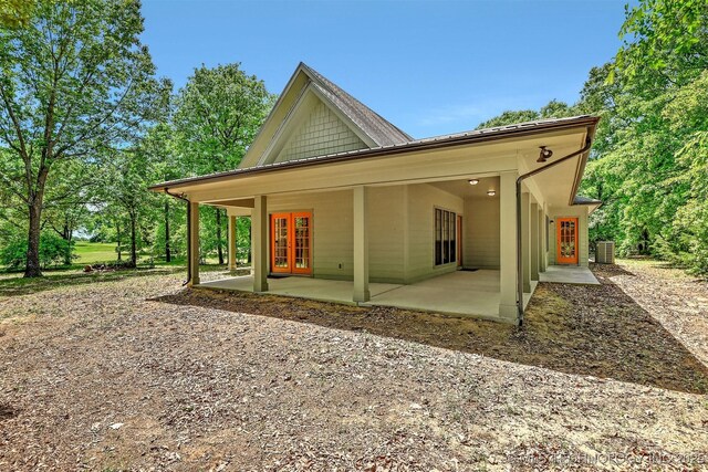 900 W Hardesty Rd, Caddo, OK 74729 - view of front facade featuring french doors, a patio, and cooling unit