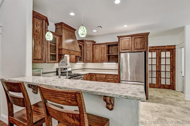 900 W Hardesty Rd, Caddo, OK 74729 - kitchen featuring appliances with stainless steel finishes, open shelves, light countertops, a peninsula, and custom exhaust hood