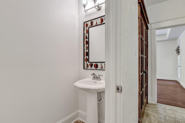 900 W Hardesty Rd, Caddo, OK 74729 - bathroom featuring baseboards and a sink