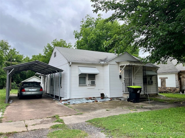 804 W 10th, Ada, OK 74820 - view of front of property with driveway, a carport, cooling unit, and a shingled roof