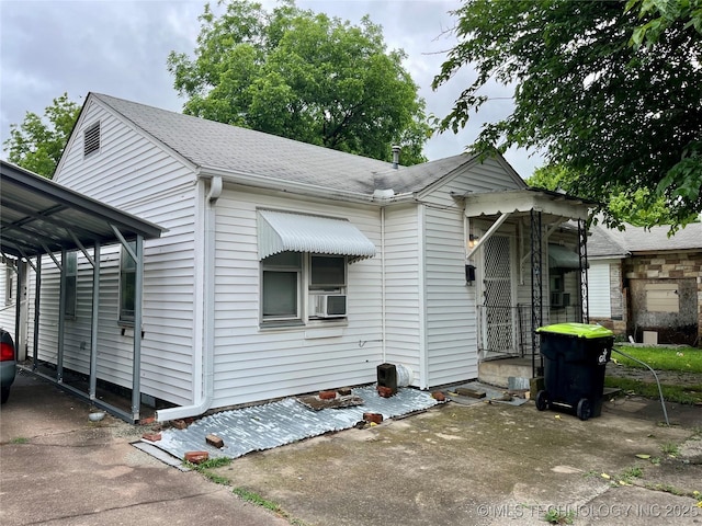 804 W 10th, Ada, OK 74820 - view of front of property with roof with shingles, a carport, and concrete driveway