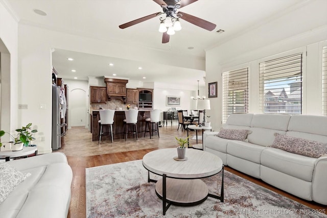 12643 S 67th E Ave, Bixby, OK 74070 - living area with light wood finished floors, a ceiling fan, recessed lighting, ornamental molding, and a chandelier