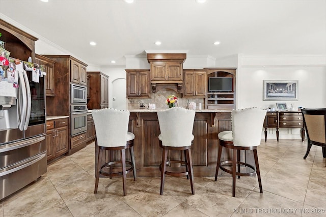 12643 S 67th E Ave, Bixby, OK 74070 - kitchen with appliances with stainless steel finishes, backsplash, recessed lighting, crown molding, and a kitchen island