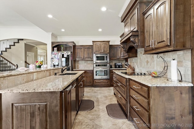 12643 S 67th E Ave, Bixby, OK 74070 - kitchen featuring stainless steel appliances, a sink, crown molding, tasteful backsplash, and light stone countertops