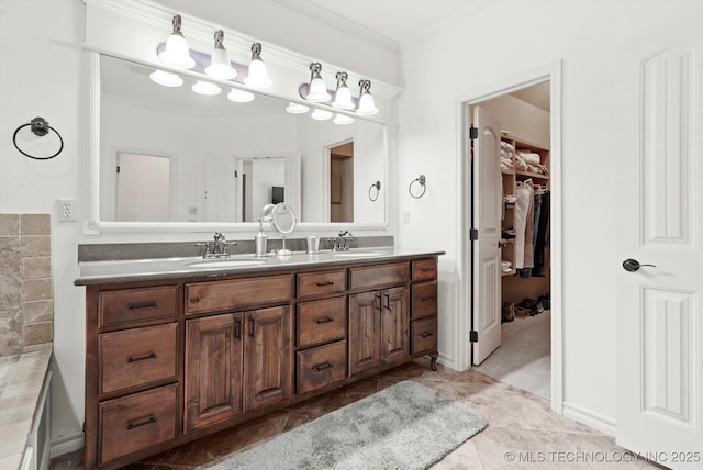 12643 S 67th E Ave, Bixby, OK 74070 - bathroom featuring double vanity, ornamental molding, and a walk in closet
