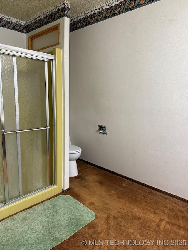 2099 S 80th St E, Muskogee, OK 74403 - full bathroom featuring toilet, a stall shower, and baseboards