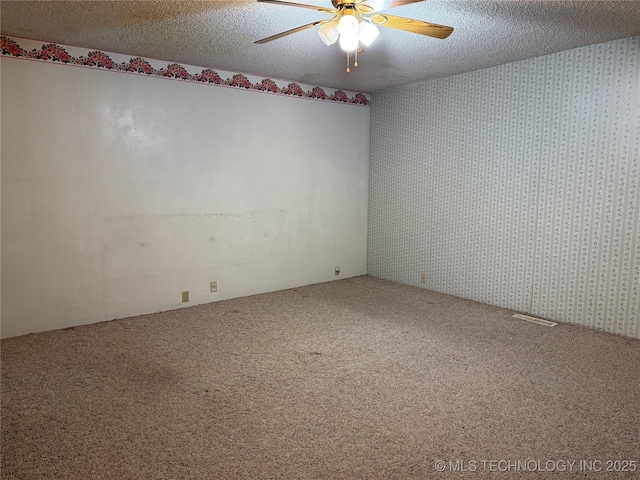 2099 S 80th St E, Muskogee, OK 74403 - carpeted spare room with wallpapered walls, ceiling fan, and a textured ceiling