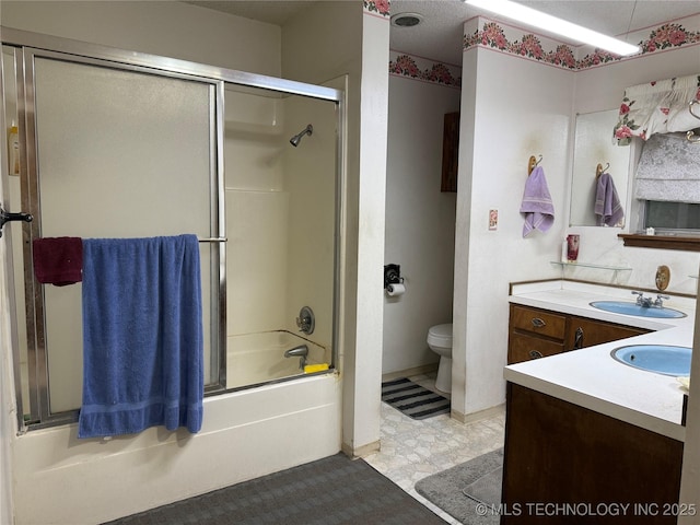 2099 S 80th St E, Muskogee, OK 74403 - bathroom featuring vanity, toilet, and shower / bath combination with glass door