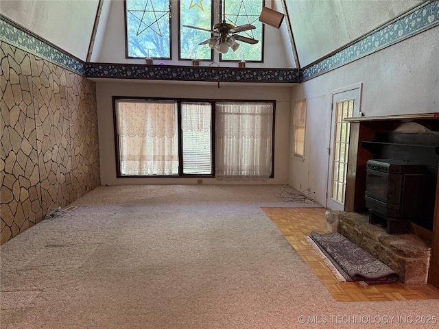 2099 S 80th St E, Muskogee, OK 74403 - living area with a towering ceiling, a wood stove, and a ceiling fan