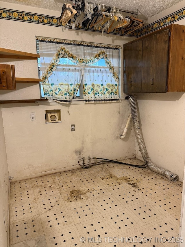 2099 S 80th St E, Muskogee, OK 74403 - washroom with electric dryer hookup, hookup for a gas dryer, cabinet space, and a textured ceiling