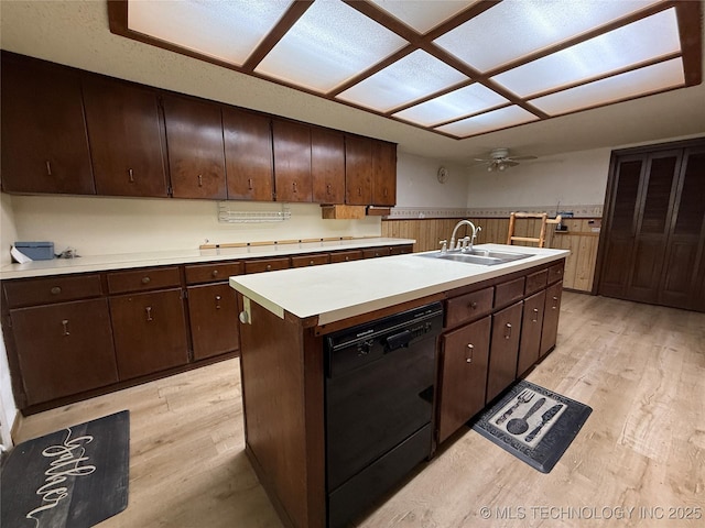 2099 S 80th St E, Muskogee, OK 74403 - kitchen with dishwasher, a sink, light wood-style flooring, light countertops, and a wainscoted wall