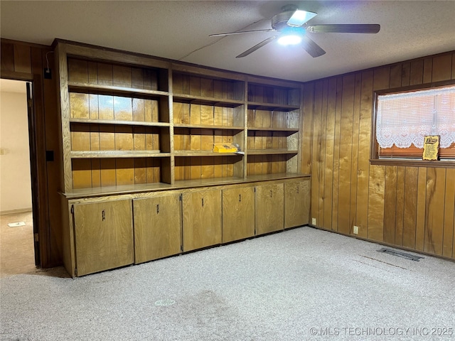 2099 S 80th St E, Muskogee, OK 74403 - carpeted spare room with ceiling fan, wooden walls, and a textured ceiling