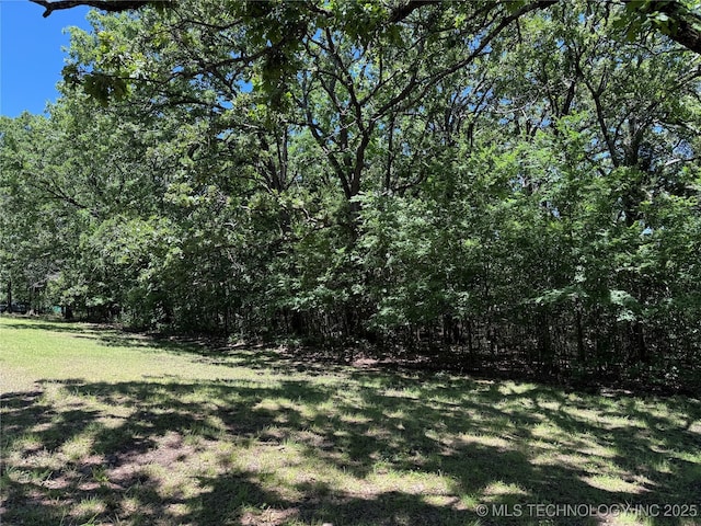 2099 S 80th St E, Muskogee, OK 74403 - view of grassy yard with a wooded view