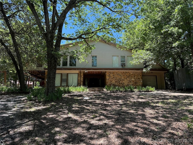 2099 S 80th St E, Muskogee, OK 74403 - traditional-style home with stone siding and an attached garage