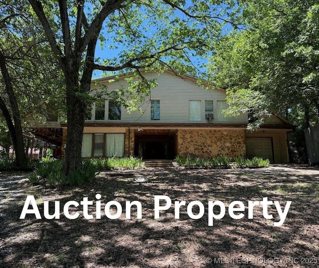 2099 S 80th St E, Muskogee, OK 74403 - view of front of property with stone siding and a garage