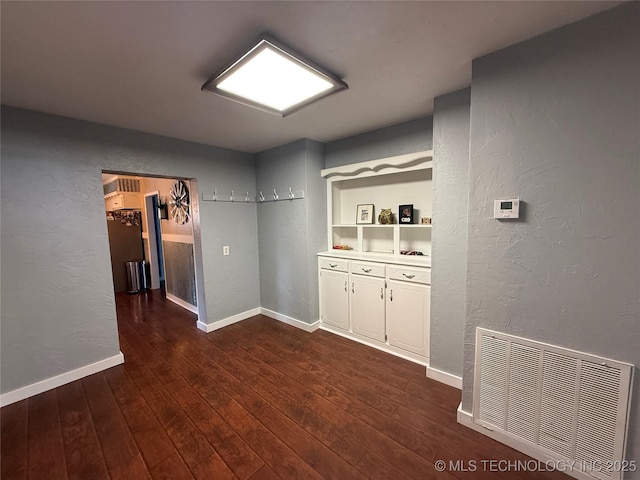 1732 N Little, Cushing, OK 74023 - bar with a textured wall, dark wood-style flooring, and baseboards