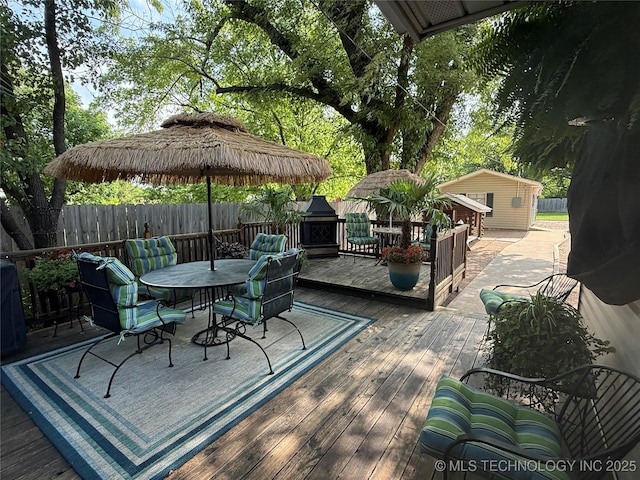 1732 N Little, Cushing, OK 74023 - wooden terrace featuring outdoor dining space and an outdoor structure