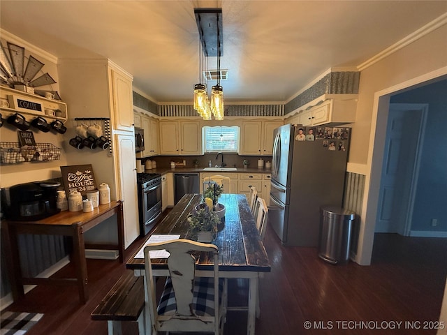 1732 N Little, Cushing, OK 74023 - kitchen with appliances with stainless steel finishes, a sink, dark wood-type flooring, crown molding, and decorative light fixtures