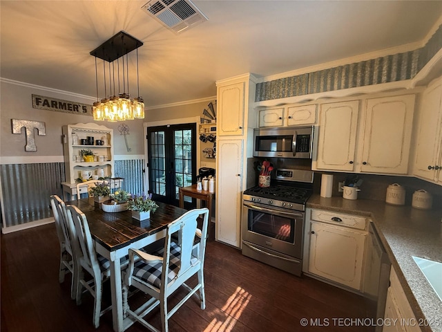 1732 N Little, Cushing, OK 74023 - kitchen with stainless steel appliances, french doors, dark wood-type flooring, pendant lighting, and a wainscoted wall