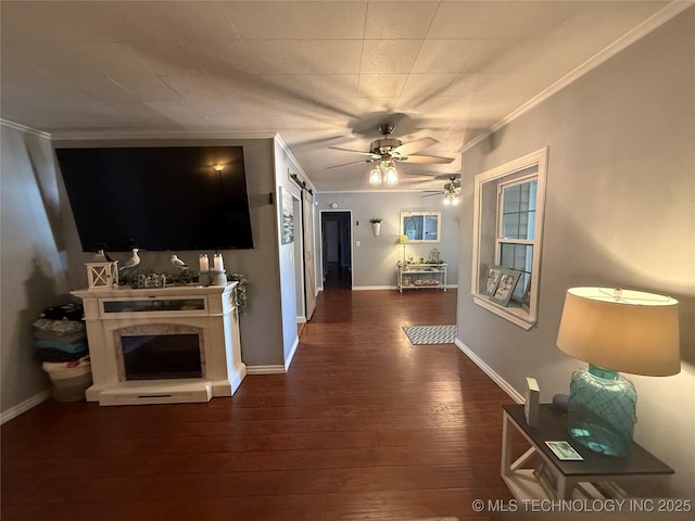 1732 N Little, Cushing, OK 74023 - living area featuring crown molding, wood-type flooring, a ceiling fan, baseboards, and a barn door