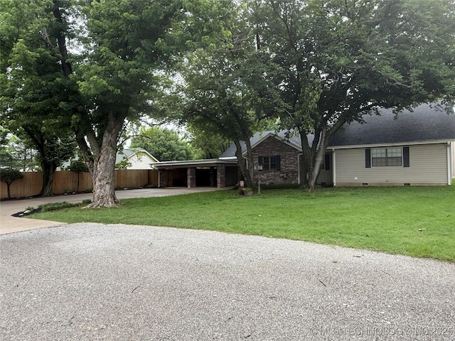 1732 N Little, Cushing, OK 74023 - view of front of house featuring concrete driveway, an attached carport, and crawl space