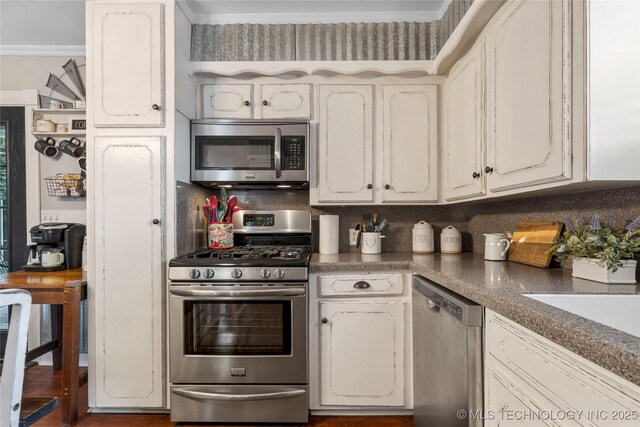 1732 N Little, Cushing, OK 74023 - kitchen with stainless steel appliances, crown molding, white cabinets, dark countertops, and tasteful backsplash