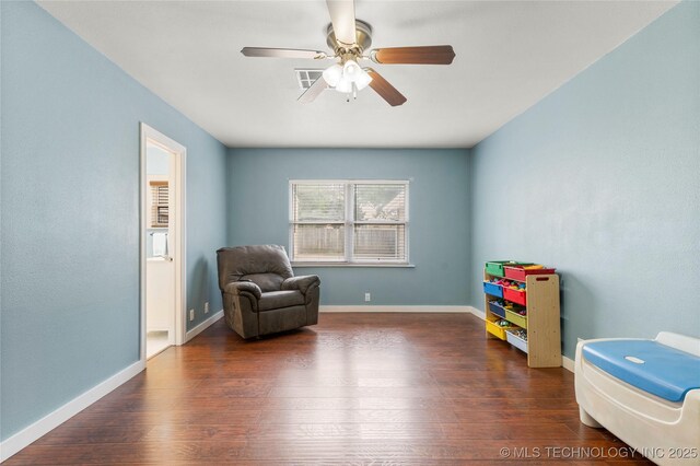 1732 N Little, Cushing, OK 74023 - sitting room featuring wood finished floors and a ceiling fan