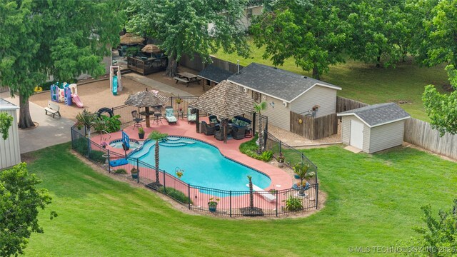 1732 N Little, Cushing, OK 74023 - view of swimming pool featuring a gazebo, a fenced backyard, a patio area, and a storage shed