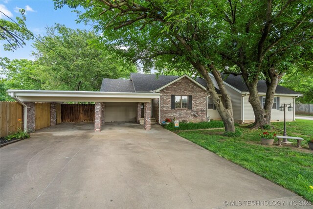 1732 N Little, Cushing, OK 74023 - view of front of house featuring brick siding, a carport, and concrete driveway