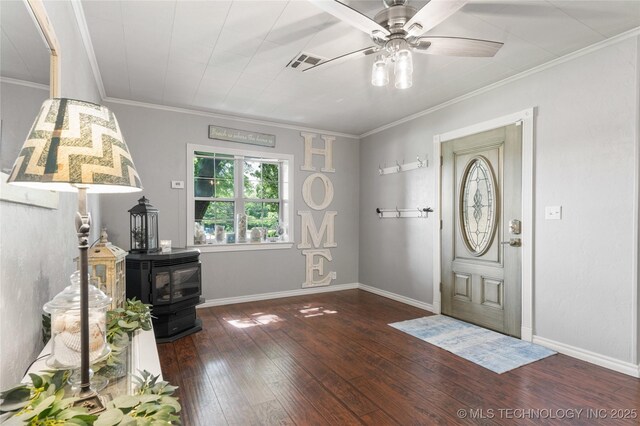 1732 N Little, Cushing, OK 74023 - entrance foyer featuring a wood stove, hardwood / wood-style flooring, ceiling fan, and crown molding