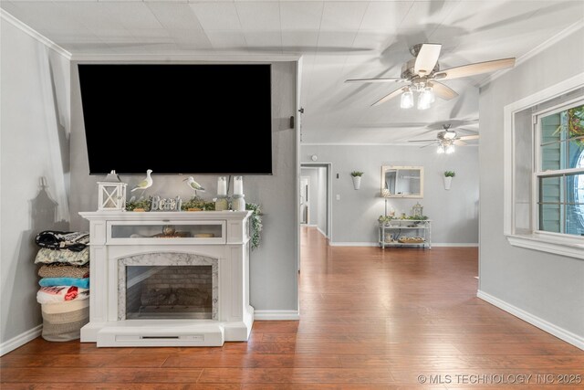 1732 N Little, Cushing, OK 74023 - living room with hardwood / wood-style flooring, a ceiling fan, a fireplace, and crown molding